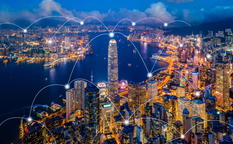 Digital network connection lines of Hong Kong Downtown. Financial district and business centers in smart city in technology concept. Skyscraper and high-rise buildings. Aerial view at night